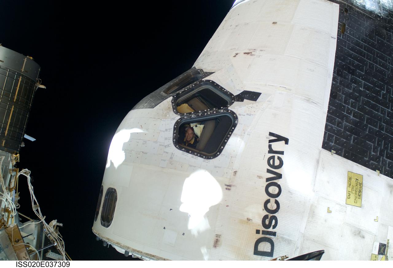 ISS020-E-037309 (1 Sept. 2009) --- One of the space-walking astronauts on the STS-128 mission's first session of extravehicular activity (EVA)captured this electronic still image of the Space Shuttle Discovery's cabin. Construction and maintenance continued on the International Space Station during the six-hour, 35-minute spacewalk of astronauts Nicole Stott and  John "Danny" Olivas (both out of frame), mission specialist.  Among their accomplishments, they removed an empty ammonia tank from the station's truss and temporarily stowed it on the station's robotic arm. Olivas and Stott also retrieved the European Technology Exposure Facility (EuTEF) and Materials International Space Station Experiment (MISSE) from the Columbus laboratory module and installed them on Discovery's payload bay for return.