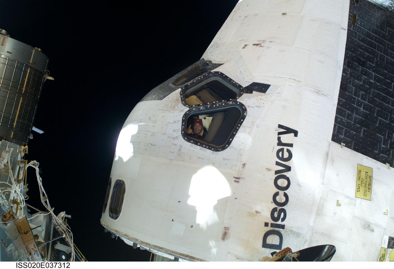 ISS020-E-037312 (1 Sept. 2009) --- This scene, showing the cabin of Space Shuttle Discovery while docked with the International Space Station, was photographed by one of the space walking astronauts during the mission?s first session of extravehicular activity (EVA). Astronaut Rick Sturckow, STS-128 commander, can be seen through a forward flight deck window.