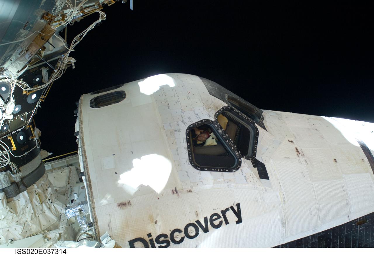 ISS020-E-037314 (1 Sept. 2009) --- This scene, showing the cabin of Space Shuttle Discovery while docked with the International Space Station, was photographed by one of the space walking astronauts during the mission?s first session of extravehicular activity (EVA). Astronaut Rick Sturckow, STS-128 commander, can be seen through a forward flight deck window.