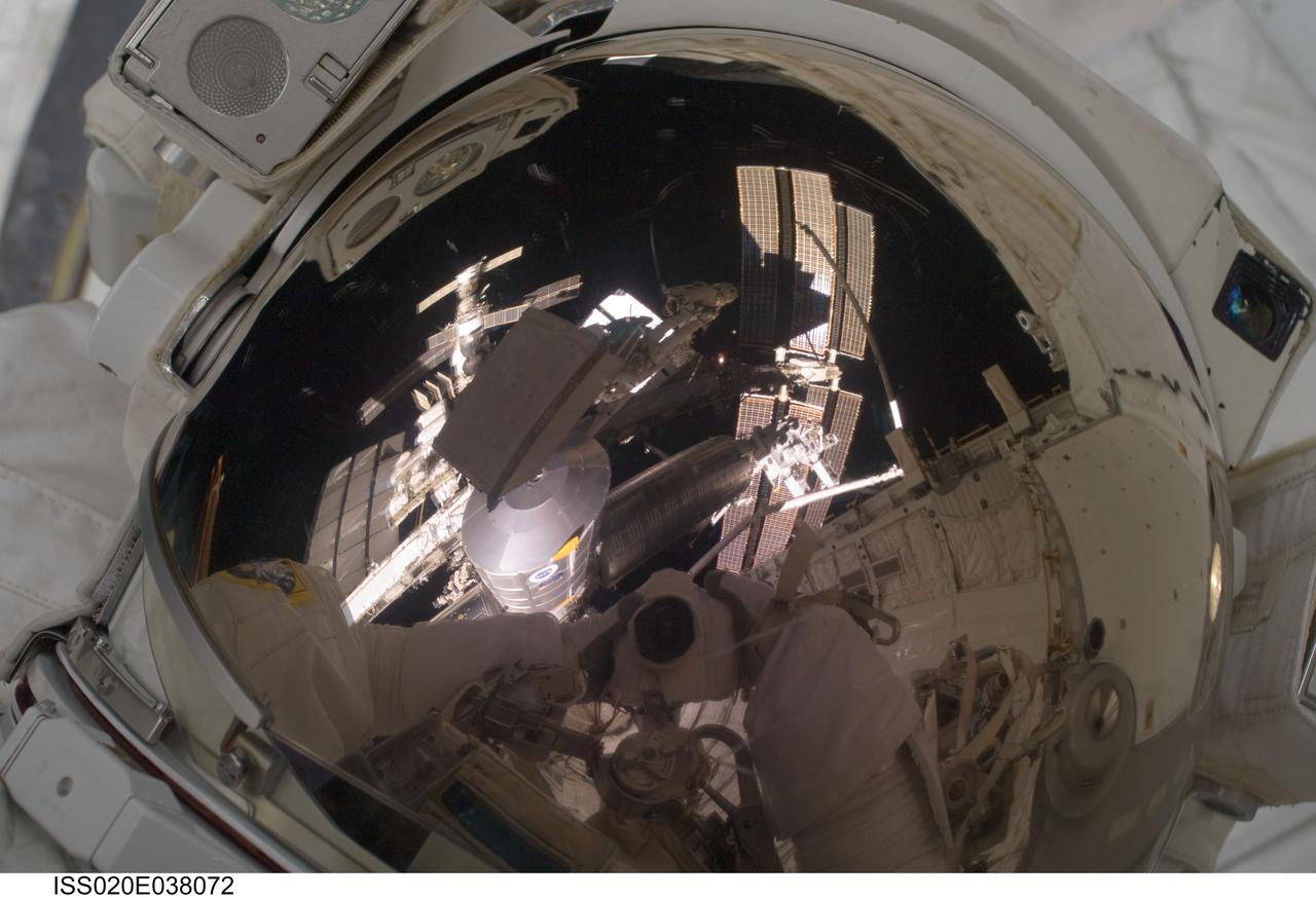 ISS020-E-038072 (3 Sept. 2009) --- NASA astronaut John ?Danny? Olivas, STS-128 mission specialist, uses a digital still camera to expose a photo of his helmet visor during the mission?s second session of extravehicular activity (EVA) as construction and maintenance continue on the International Space Station. Also visible in the reflections in the visor are various components of the station and European Space Agency astronaut Christer Fuglesang, mission specialist, anchored to a Canadarm2 mobile foot restraint. During the six-hour, 39-minute spacewalk, Olivas and Fuglesang installed the new Ammonia Tank Assembly on the Port 1 Truss and stowed the empty tank assembly into the Space Shuttle Discovery?s cargo bay.