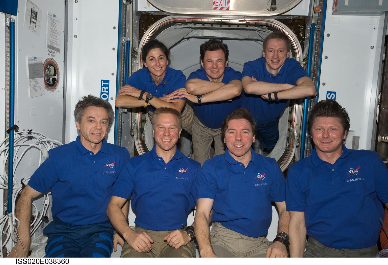 ISS020-E-038360 (5 Sept. 2009) --- These seven international astronauts and cosmonauts take a few minutes from a busy agenda to pose for a portrait on the International Space Station, where they?re spending more than a week with a second group of visitors in summer 2009, accomplishing joint activities with the STS-128 Discovery crew.  On the front row, from the left, are Canadian Aerospace Agency astronaut Robert Thirsk, and NASA astronauts Tim Kopra and Mike Barratt, with Russia?s Federal Space Agency cosmonaut Gennady Padalka. Appearing above them, as though suspended by invisible wires, are, from the left, astronaut  Nicole Stott with cosmonaut Roman Romanenko  and European Space Agency astronaut Frank De Winne.  Stott replaces Kopra, who will be returning to Earth in a few days aboard Discovery.