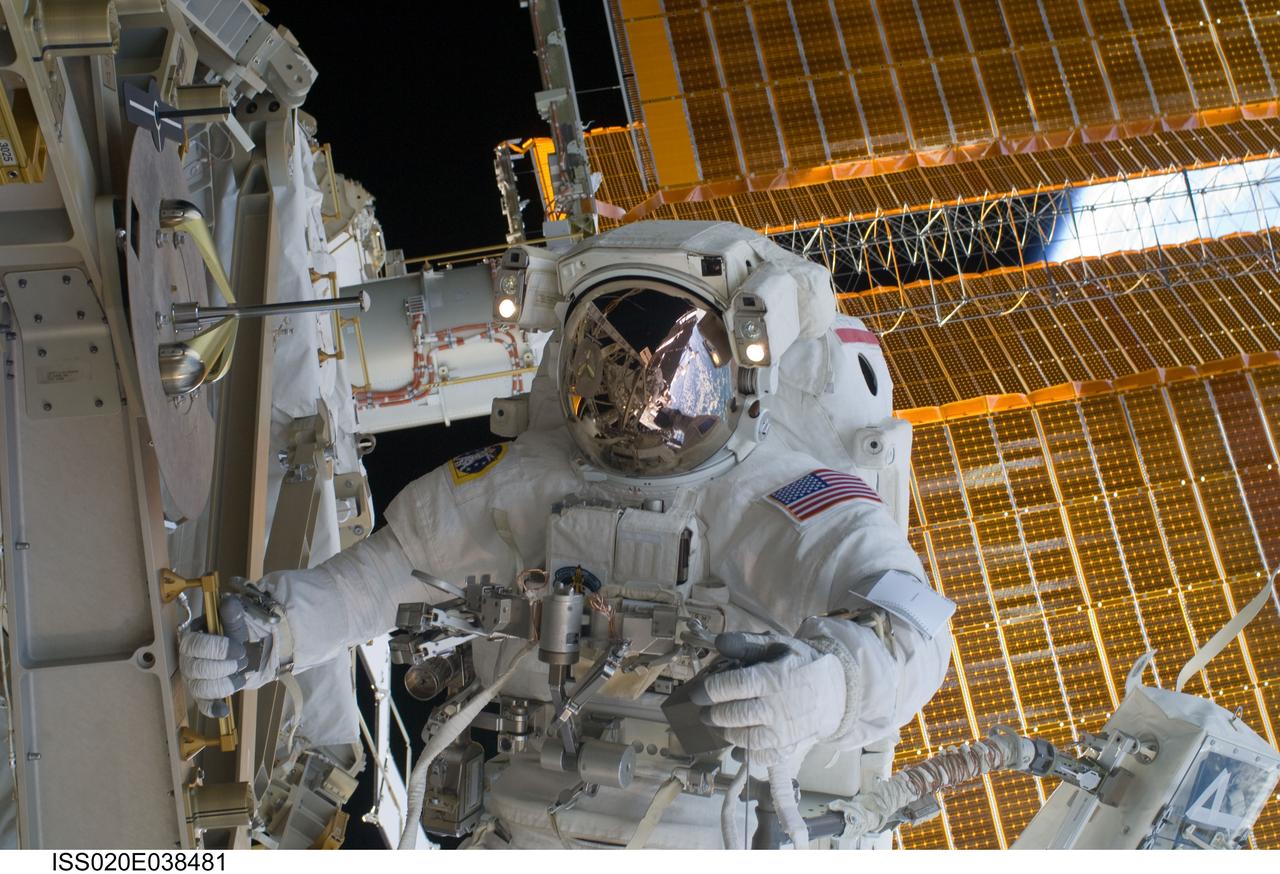 ISS020-E-038481 (5 Sept. 2009) --- NASA astronaut John ?Danny? Olivas, STS-128 mission specialist, participates in the mission's third and final session of extravehicular activity (EVA) as construction and maintenance continue on the International Space Station. Visible in the reflections of his helmet visor are various components of the station, Earth's horizon and European Space Agency astronaut Christer Fuglesang, mission specialist. During the seven-hour, one-minute spacewalk, Olivas and Fuglesang deployed the Payload Attachment System (PAS), replaced the Rate Gyro Assembly #2, installed two GPS antennae and did some work to prepare for the installation of Node 3 next year. During connection of one of two sets of avionics cables for Node 3, one of the connectors could not be mated. This cable and connector were wrapped in a protective sleeve and safed. All other cables were mated successfully.