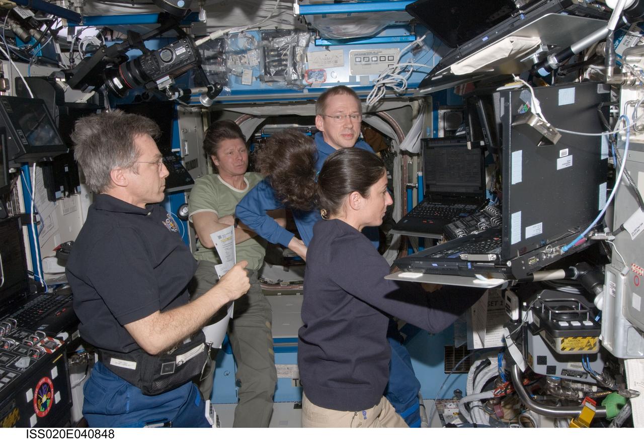 ISS020-E-040848 (17 Sept. 2009) --- At the Canadarm2 work station in the Destiny laboratory, NASA astronaut Nicole Stott, European Space Agency astronaut Frank De Winne (right background) and Canadian Space Agency astronaut Robert Thirsk (left foreground), all Expedition 20 flight engineers; along with Russian cosmonaut Gennady Padalka, commander, monitor the unpiloted Japanese H-II Transfer Vehicle (HTV) as it approaches the International Space Station. Once the HTV was in range, Stott, De Winne and Thirsk used the station’s robotic arm to grab the cargo craft and attach it to the Earth-facing port of the Harmony node. The attachment was completed at 5:26 (CDT) on Sept. 17, 2009.