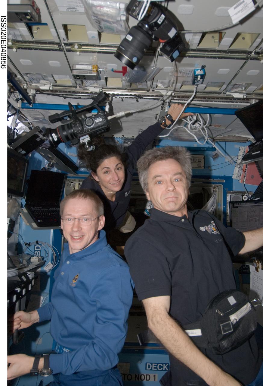 ISS020-E-040856 (17 Sept. 2009) --- NASA astronaut Nicole Stott, European Space Agency astronaut Frank De Winne (left) and Canadian Space Agency astronaut Robert Thirsk, all Expedition 20 flight engineers, take a moment for a photo in the Destiny laboratory of the International Space Station after completing the attachment of the unpiloted Japanese H-II Transfer Vehicle (HTV) to the station. Stott, De Winne and Thirsk used the station’s robotic arm to grab the cargo craft and attach it to the Earth-facing port of the Harmony node. The attachment was completed at 5:26 (CDT) on Sept. 17, 2009.