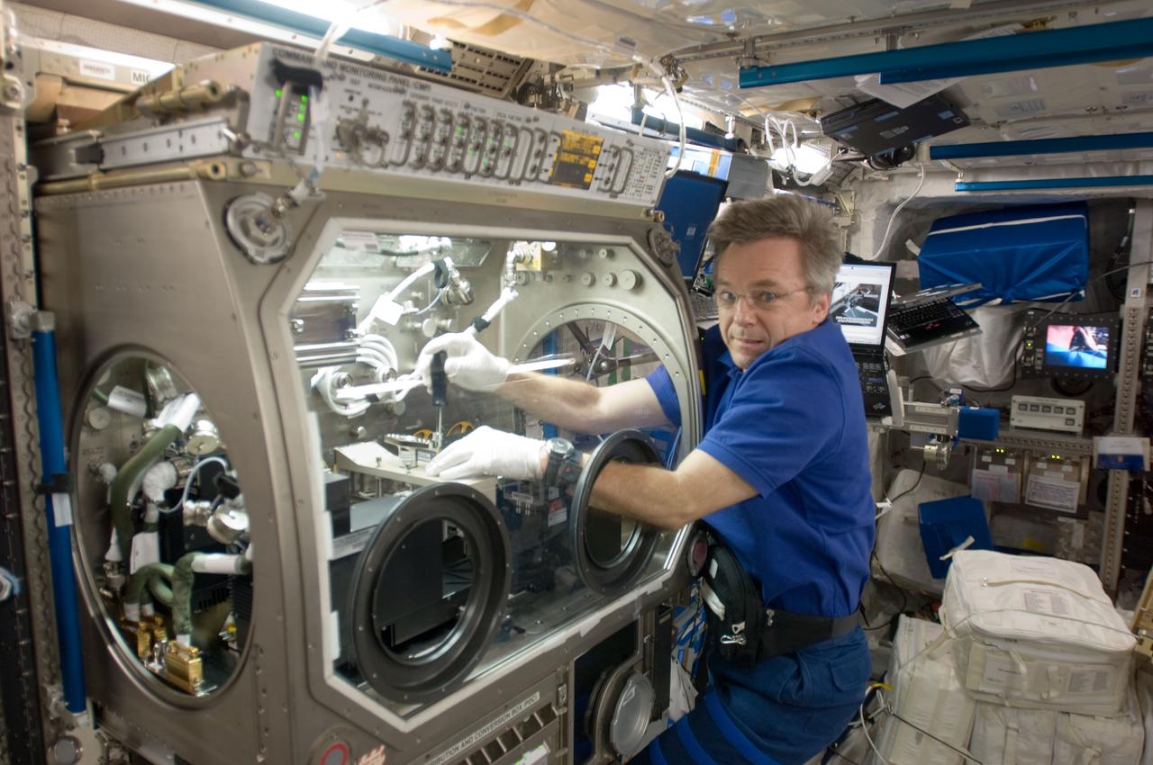 ISS020-E-041873 (23 Sept. 2009) --- Canadian Space Agency astronaut Robert Thirsk, Expedition 20 flight engineer, works with experiment hardware in the Microgravity Science Glovebox (MSG) located in the Columbus laboratory of the International Space Station.