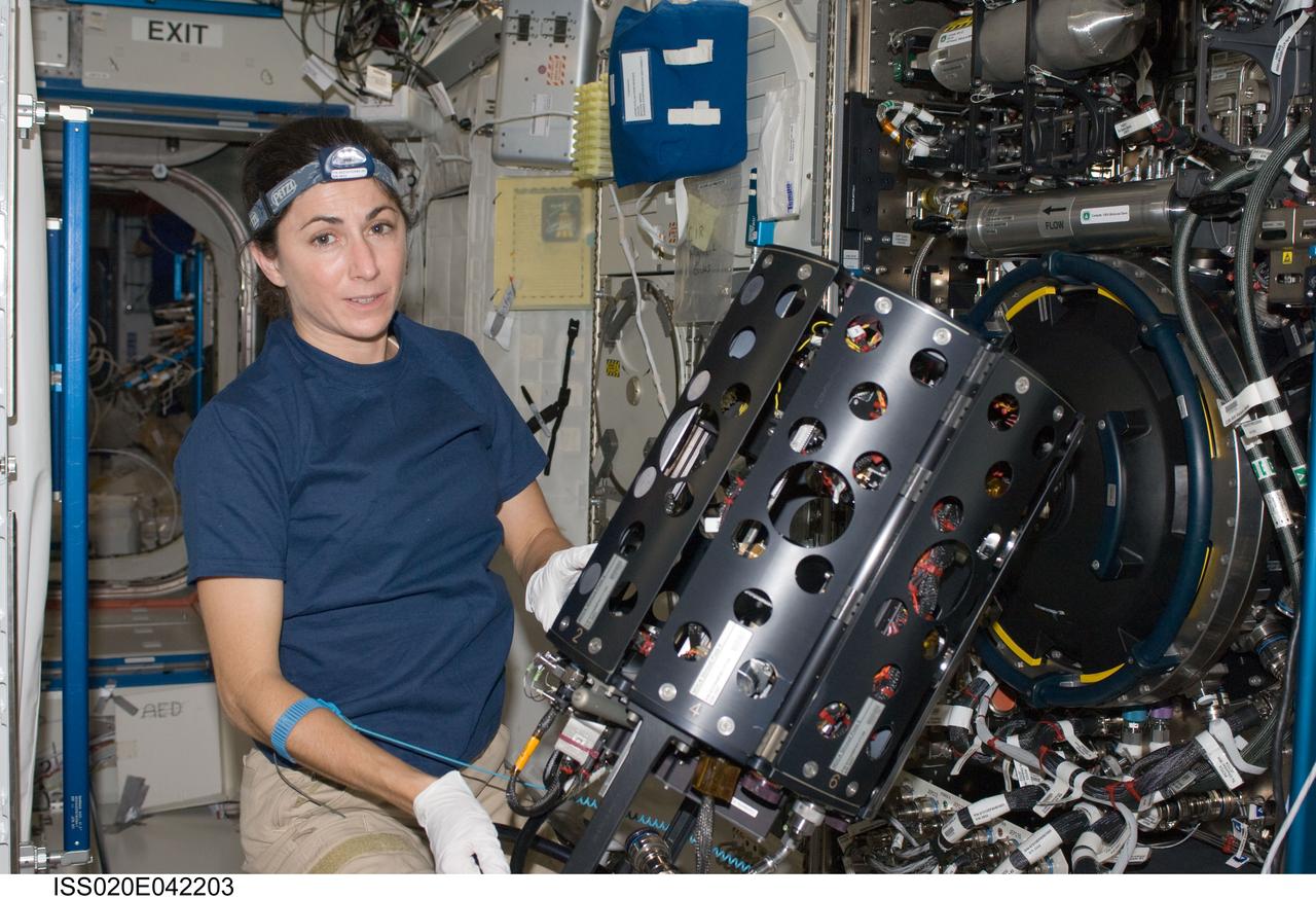 ISS020-E-042203 (26 Sept. 2009) --- NASA astronaut Nicole Stott, Expedition 20 flight engineer, works with the Combustion Integrated Rack (CIR) in the Destiny laboratory of the International Space Station.