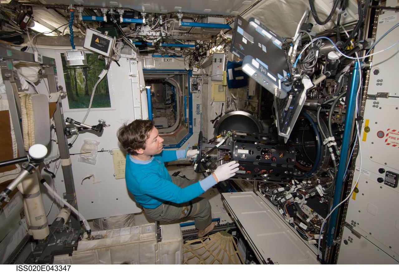 ISS020-E-043347 (26 Sept. 2009) --- NASA astronaut Michael Barratt, Expedition 20 flight engineer, works with the Multi-user Droplet Combustion Apparatus / Chamber Insert Assembly (MDCA CIA) in the Combustion Integrated Rack (CIR) located in the Destiny laboratory of the International Space Station.