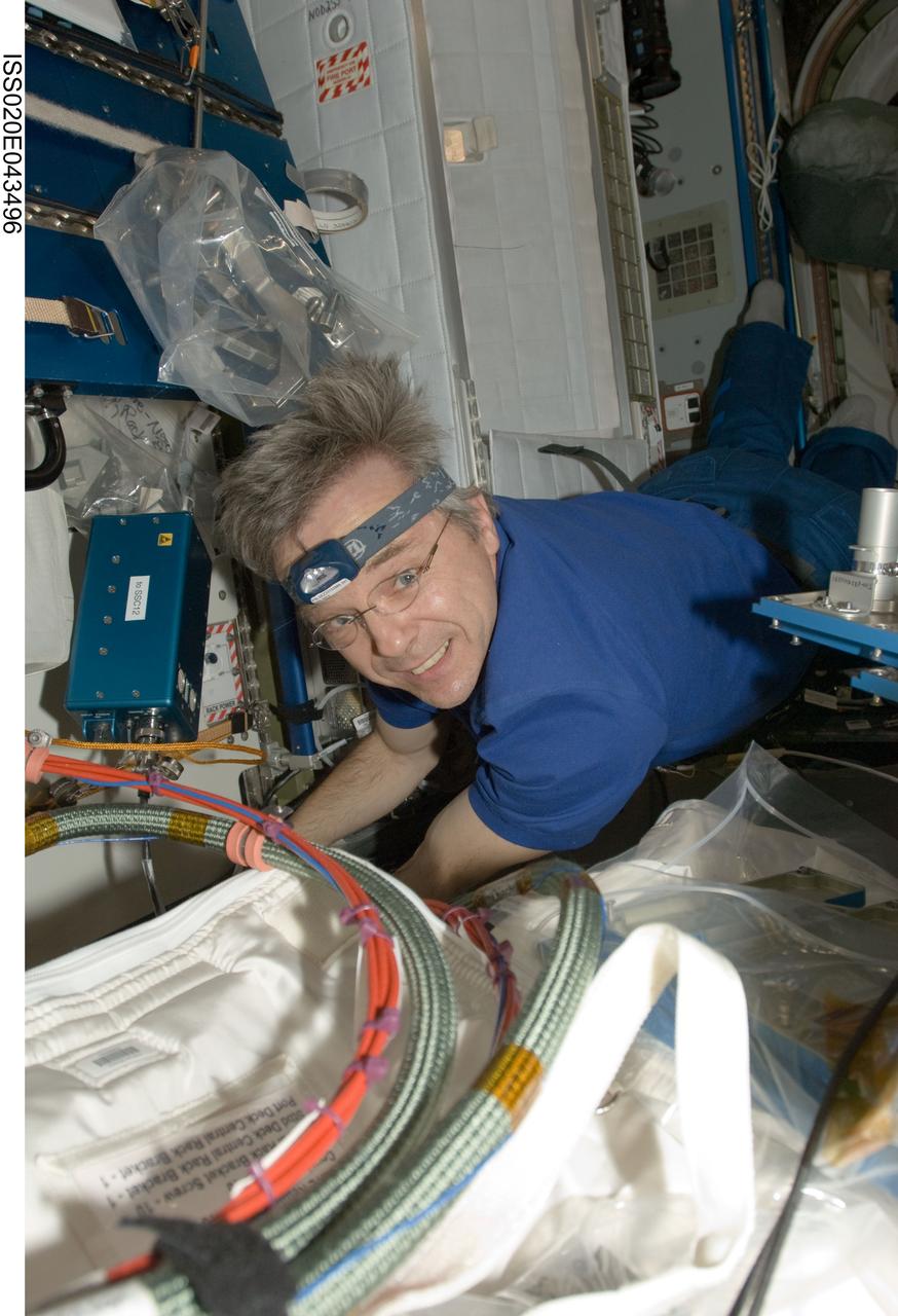 ISS020-E-043496 (29 Sept. 2009) --- Canadian Space Agency astronaut Robert Thirsk, Expedition 20 flight engineer, performs in-flight maintenance (IFM) in the Harmony node of the International Space Station.
