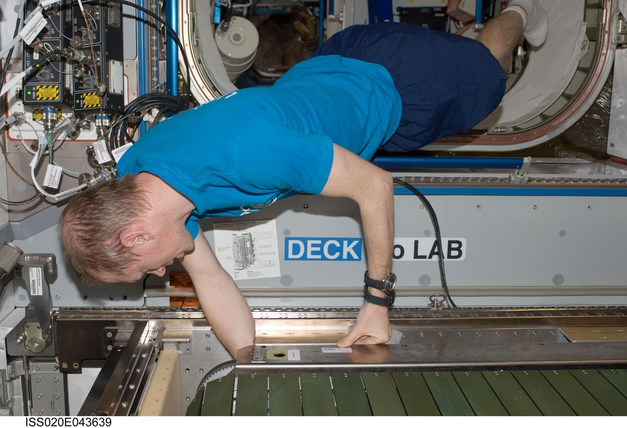 ISS020-E-043639 (30 Sept. 2009) --- European Space Agency astronaut Frank De Winne, Expedition 20 flight engineer, assembles and installs the Combined Operational Load Bearing External Resistance Treadmill (COLBERT) in its temporary place in the Harmony node of the International Space Station.