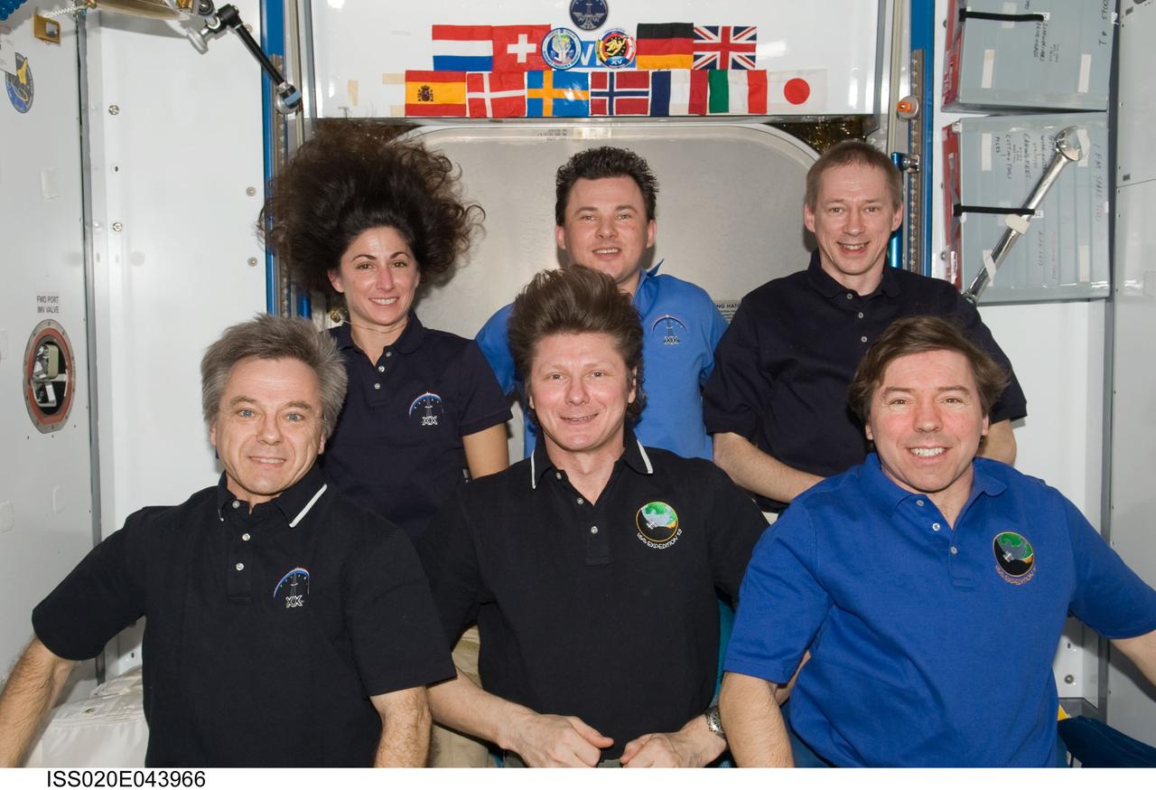 ISS020-E-043966 (1 Oct. 2009) --- Expedition 20 crew members pose for an in-flight crew photo in the Harmony node of the International Space Station. On the front row are Russian cosmonaut Gennady Padalka (center), commander; along with Canadian Space Agency astronaut Robert Thirsk (left) and NASA astronaut Michael Barratt, both flight engineers. Pictured from the left (back row) are NASA astronaut Nicole Stott, Russian cosmonaut Roman Romanenko and European Space Agency astronaut Frank De Winne, all flight engineers.