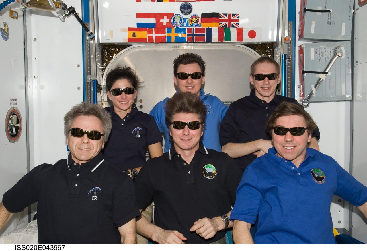 ISS020-E-043967 (1 Oct. 2009) --- Expedition 20 crew members pose for an in-flight crew photo in the Harmony node of the International Space Station. On the front row are Russian cosmonaut Gennady Padalka (center), commander; along with Canadian Space Agency astronaut Robert Thirsk (left) and NASA astronaut Michael Barratt, both flight engineers. Pictured from the left (back row) are NASA astronaut Nicole Stott, Russian cosmonaut Roman Romanenko and European Space Agency astronaut Frank De Winne, all flight engineers.