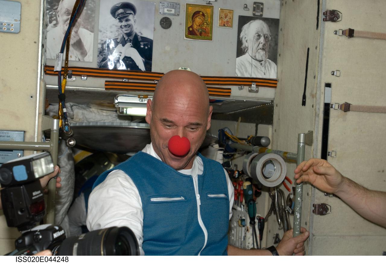 ISS020-E-044248 (2 Oct. 2009) --- Spaceflight participant Guy Laliberte is pictured wearing a clown nose in the Zvezda Service Module of the International Space Station, shortly after arriving onboard a Soyuz spacecraft with two Expedition 21 crew members (out of frame).