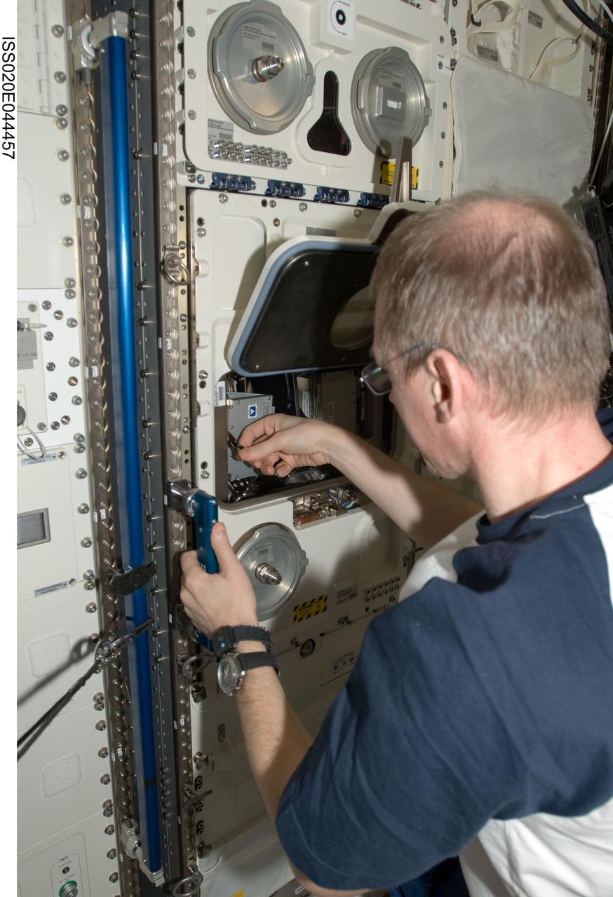 ISS020-E-044457 (2 Oct. 2009) --- European Space Agency astronaut Frank De Winne, Expedition 20 flight engineer and Expedition 21 commander, installs experiment containers in the Biolab incubator in the Columbus laboratory of the International Space Station.