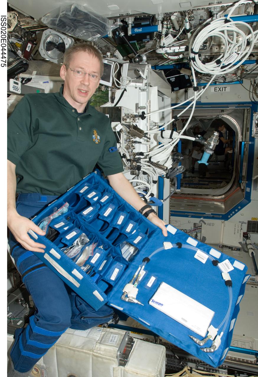 ISS020-E-044475 (3 Oct. 2009) --- European Space Agency astronaut Frank De Winne, Expedition 20 flight engineer and Expedition 21 commander, holds a Portable Pulmonary Function System (PPFS) stowage bag in the Destiny laboratory of the International Space Station.