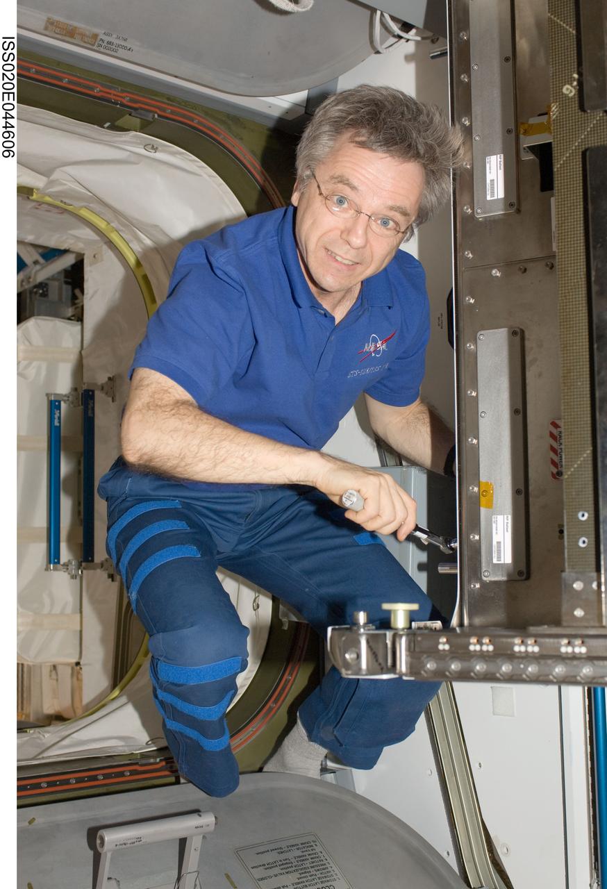 ISS020-E-044606 (30 Sept. 2009) --- Canadian Space Agency astronaut Robert Thirsk, Expedition 20 flight engineer, performs in-flight maintenance (IFM) in the Harmony node of the International Space Station.