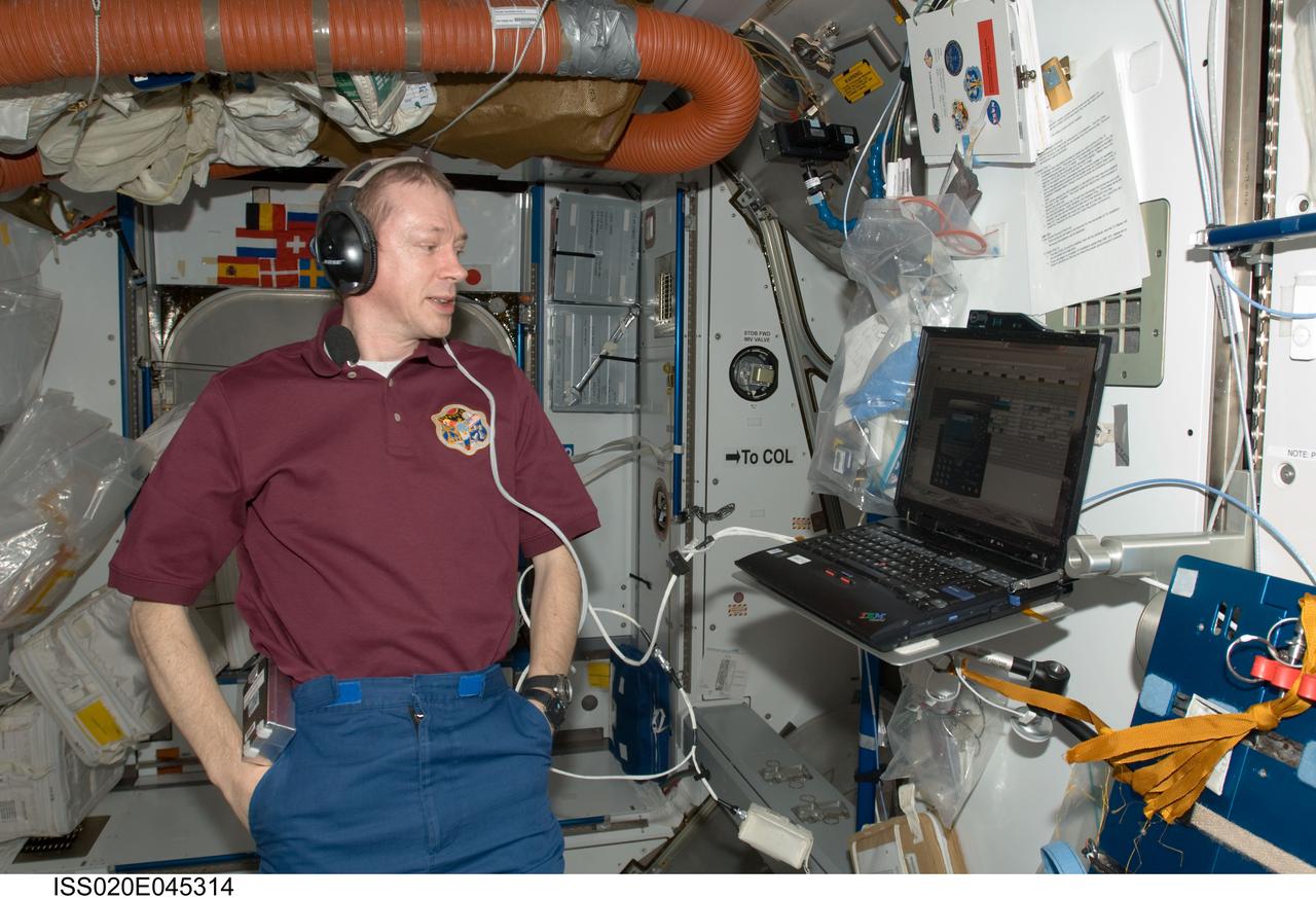 ISS020-E-045314 (5 Oct. 2009) --- European Space Agency astronaut Frank De Winne, Expedition 20 flight engineer and Expedition 21 commander, uses a communication system near a computer in the Harmony node of the International Space Station.