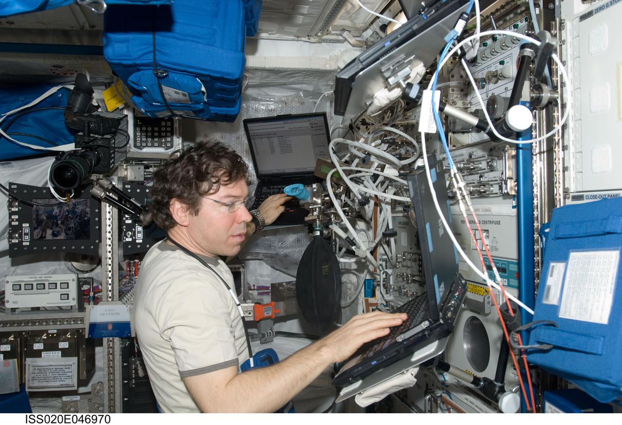 ISS020-E-046970 (6 Oct. 2009) --- NASA astronaut Michael Barratt, Expedition 20 flight engineer, enters data into computers in the Columbus laboratory of the International Space Station.