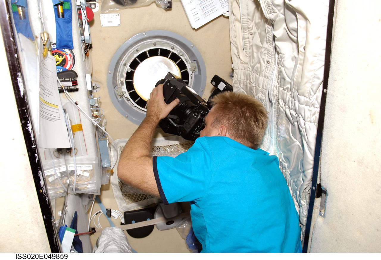 ISS020-E-049859 (8 Oct. 2009) --- Russian cosmonaut Maxim Suraev, Expedition 21/22 flight engineer, uses science hardware RUSALKA at a window in the Zvezda Service Module of the International Space Station to take methane and carbon dioxide measurements in Earth's atmosphere at sunset.