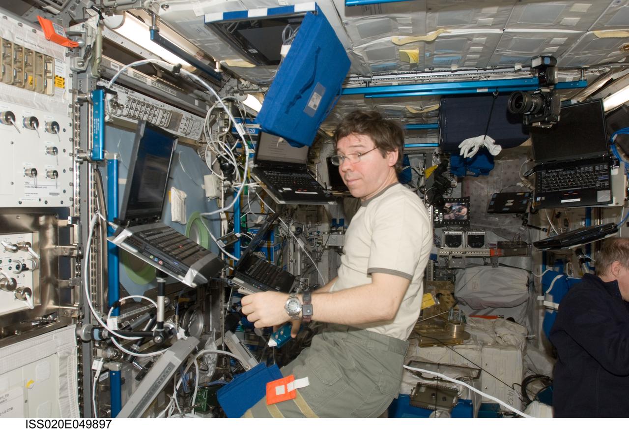 ISS020-E-049897 (8 Oct. 2009) --- NASA astronaut Michael Barratt, Expedition 20 flight engineer, works in the Columbus laboratory of the International Space Station.