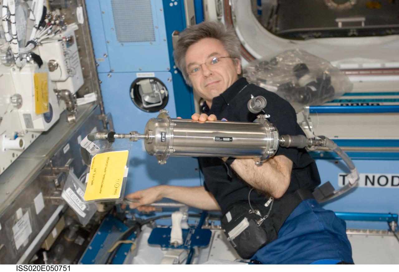 ISS020-E-050751 (10 Oct. 2009) --- Canadian Space Agency astronaut Robert Thirsk, Expedition 20/21 flight engineer, holds an Antimicrobial Applicator (AmiA) in the Kibo laboratory of the International Space Station.