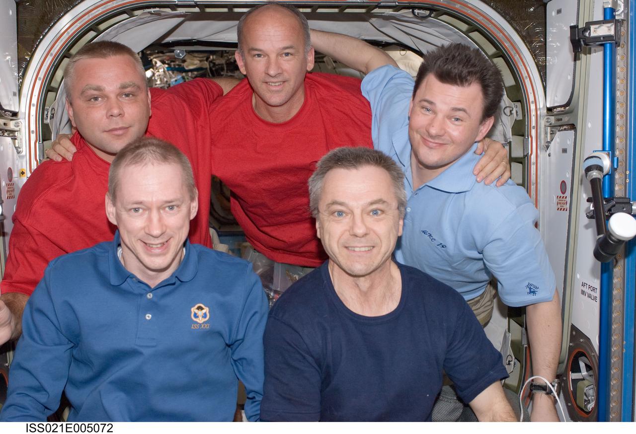 ISS021-E-005072 (11 Oct. 2009) --- Five of the six crew members on the International Space Station pose for a photo in the Harmony node. Pictured on the front row are European Space Agency astronaut Frank De Winne (left), Expedition 21 commander; and Canadian Space Agency astronaut Robert Thirsk, flight engineer. Pictured from the left (back row) are Russian cosmonaut Maxim Suraev, NASA astronaut Jeffrey Williams and Russian cosmonaut Roman Romanenko, all flight engineers.