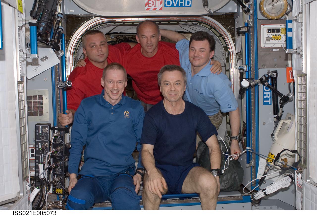 ISS021-E-005073 (11 Oct. 2009) --- Five of the six crew members on the International Space Station pose for a photo in the Harmony node. Pictured on the front row are European Space Agency astronaut Frank De Winne (left), Expedition 21 commander; and Canadian Space Agency astronaut Robert Thirsk, flight engineer. Pictured from the left (back row) are Russian cosmonaut Maxim Suraev, NASA astronaut Jeffrey Williams and Russian cosmonaut Roman Romanenko, all flight engineers.