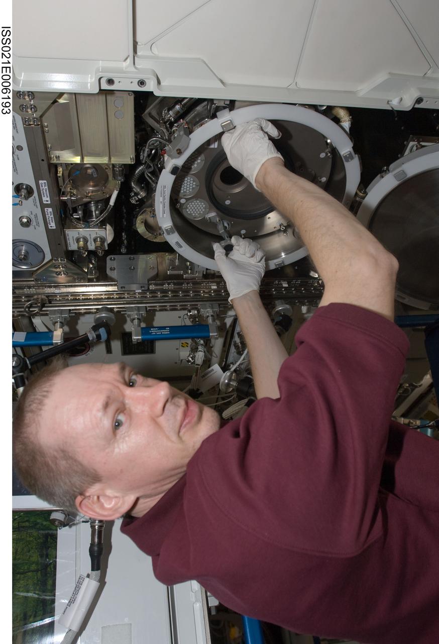 ISS021-E-006193 (14 Oct. 2009) --- European Space Agency astronaut Frank De Winne, Expedition 21 commander, works with a Materials Science Laboratory (MSL) chamber in the Destiny laboratory of the International Space Station.