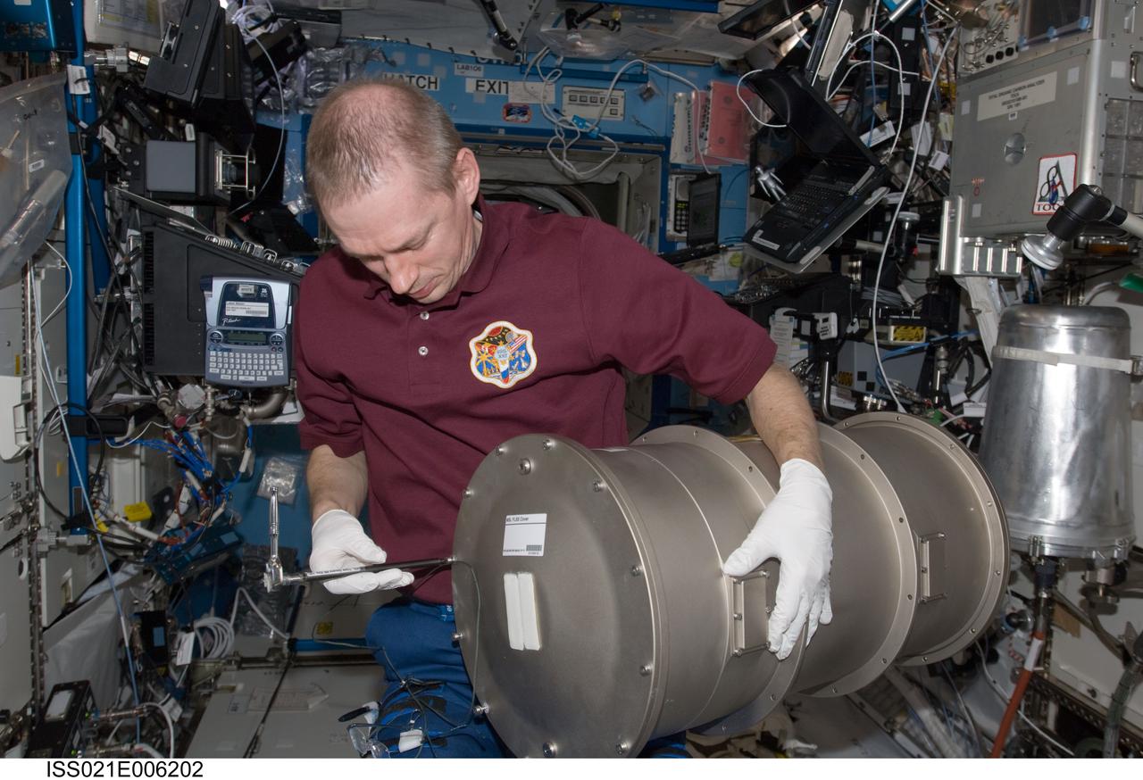 ISS021-E-006202 (14 Oct. 2009) --- European Space Agency astronaut Frank De Winne, Expedition 21 commander, works with Materials Science Laboratory (MSL) hardware in the Destiny laboratory of the International Space Station.