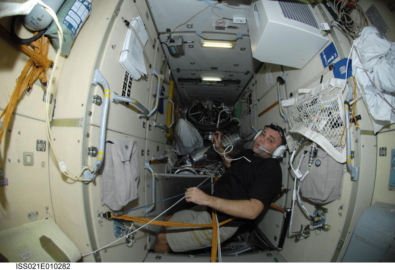 ISS021-E-010282 (21 Oct. 2009) --- Russian cosmonaut Maxim Suraev, Expedition 21 flight engineer, uses a communication system while working in the Zarya Functional Cargo Block (FGB) of the International Space Station.