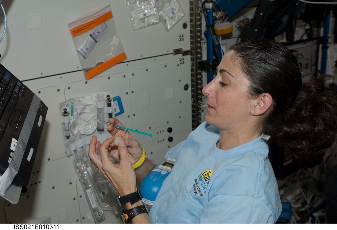 ISS021-E-010311 (20 Oct. 2009) --- NASA astronaut Nicole Stott, Expedition 21 flight engineer, conducts a water quality analysis using the Colorimetric Water Quality Monitoring Kit (CWQMK) in the Destiny laboratory of the International Space Station.