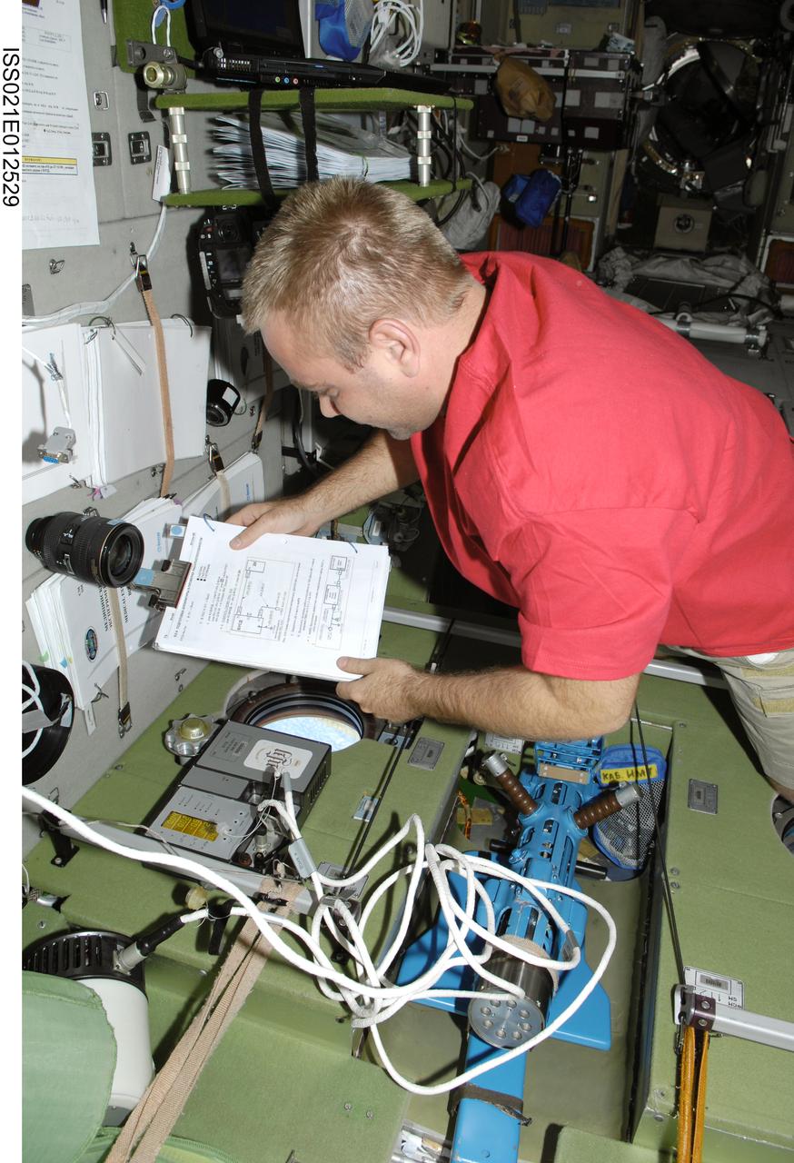 ISS021-E-012529 (26 Oct. 2009) --- Russian cosmonaut Maxim Suraev, Expedition 21 flight engineer, works in the Zvezda Service Module of the International Space Station.