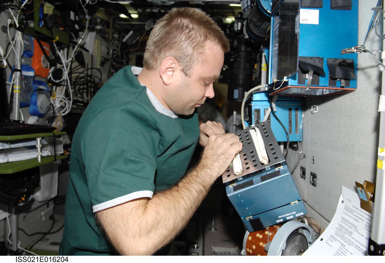 ISS021-E-016204 (29 Oct. 2009) --- Russian cosmonaut Maxim Suraev, Expedition 21 flight engineer, works with a new growth experiment on the BIO-5 Rasteniya-2 (Plants-2) payload in the Zvezda Service Module of the International Space Station.