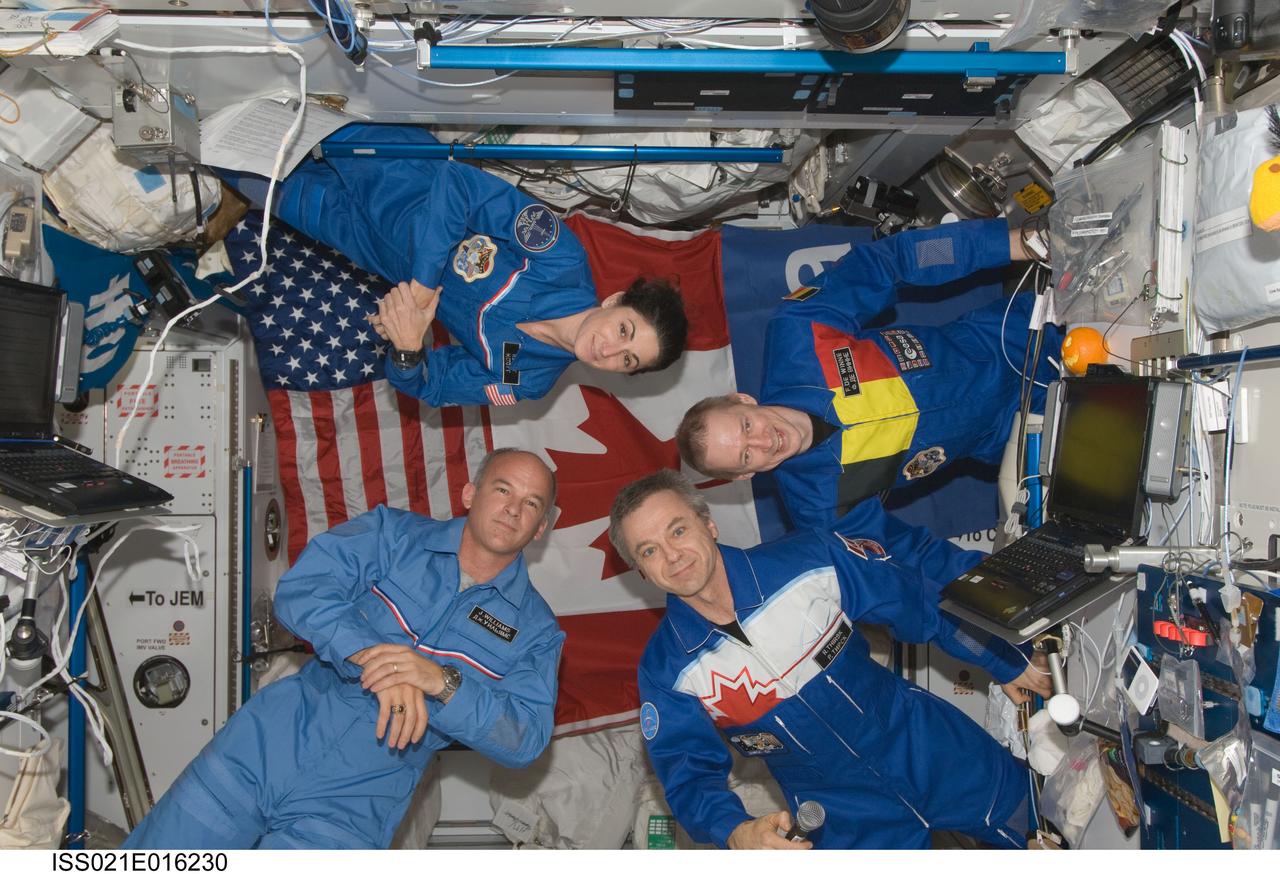 ISS021-E-016230 (28 Oct. 2009) --- European Space Agency astronaut Frank De Winne (right), Expedition 21 commander; along with Canadian Space Agency astronaut Robert Thirsk (bottom right), NASA astronauts Jeffrey Williams and Nicole Stott, all flight engineers, are pictured during an educational event set up by the Canadian Space Agency for the Minister of Education at Mount St. Vincent University in Halifax, Nova Scotia, Canada, with approximately 100 students, teachers, parents and province schools participating virtually throughout Nova Scotia.