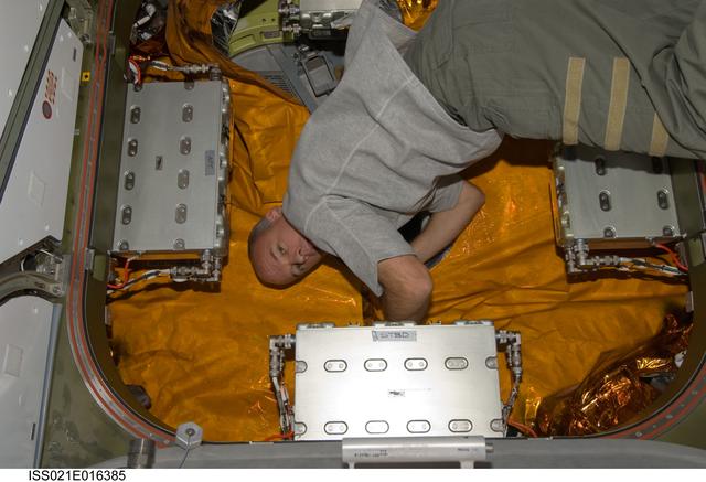 NASA image: FE-5 Williams installs a Hatch Thermal Blanket during HTV Vestibule Closeout