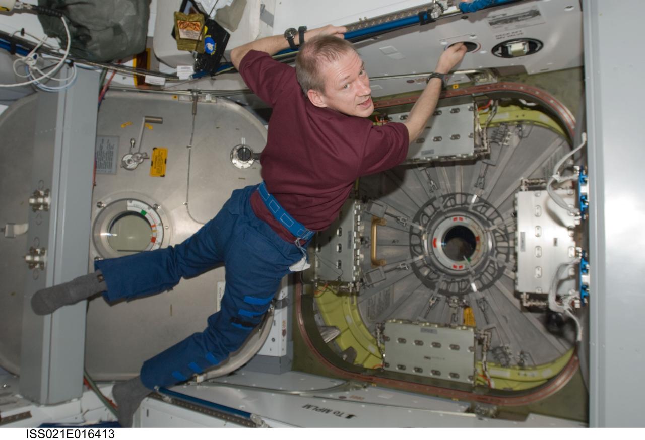 ISS021-E-016413 (29 Oct. 2009) --- European Space Agency astronaut Frank De Winne, Expedition 21 commander, works near the vestibule between the International Space Station’s Harmony node and the Japanese H-II Transfer Vehicle (HTV) in preparation for the release of the HTV scheduled for Oct. 30, 2009.