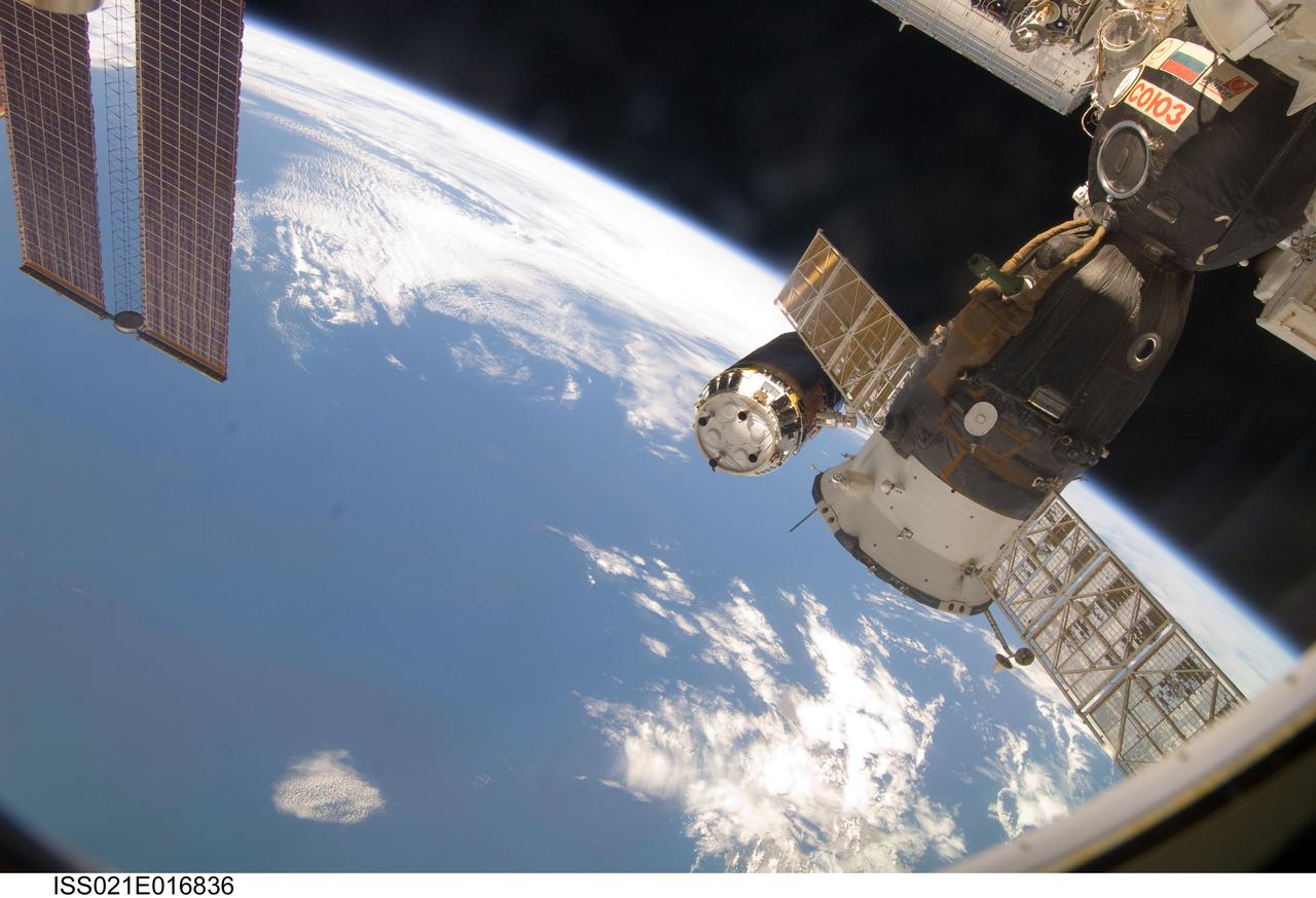 ISS021-E-016836 (30 Oct. 2009) --- Backdropped by Earth’s horizon and the blackness of space, the International Space Station's Canadarm2 (mostly obscured) unberths the unpiloted Japanese H-II Transfer Vehicle (HTV) in preparation for its release from the station. European Space Agency astronaut Frank De Winne, Expedition 21 commander; NASA astronaut Nicole Stott and Canadian Space Agency astronaut Robert Thirsk, both flight engineers, used the station’s robotic arm to grab the HTV cargo craft, filled with trash and unneeded items, and unberth it from the Harmony node’s nadir port. The HTV was successfully unberthed at 10:18 a.m. (CDT) on Oct. 30, 2009, and released from the station’s Canadarm2 at 12:32 p.m. A Russian Soyuz spacecraft, docked to the station, is visible in the foreground.