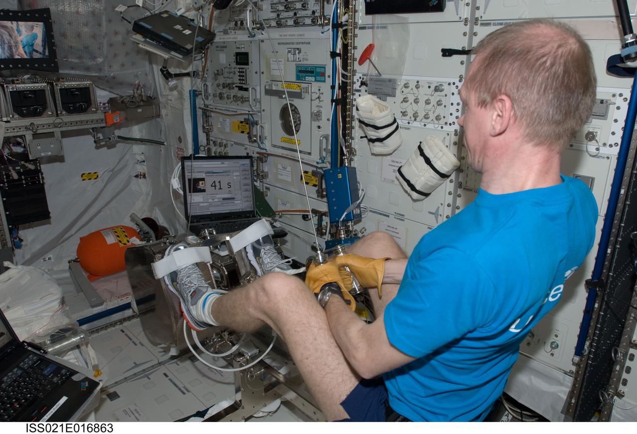 ISS021-E-016863 (28 Oct. 2009) --- European Space Agency (ESA) astronaut Frank De Winne, Expedition 21 commander, performs activation and checkout steps on the new ESA Flywheel Exercise Device (FWED), with the Internal Wireless Instrumentation System (IWIS) accelerometer, in the Columbus laboratory of the International Space Station.