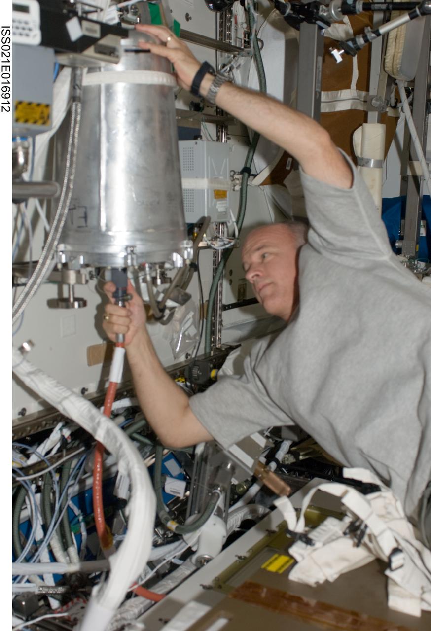 ISS021-E-016912 (30 Oct. 2009) --- NASA astronaut Jeffrey Williams, Expedition 21 flight engineer, works with the waste and hygiene compartment in the Destiny laboratory of the International Space Station.