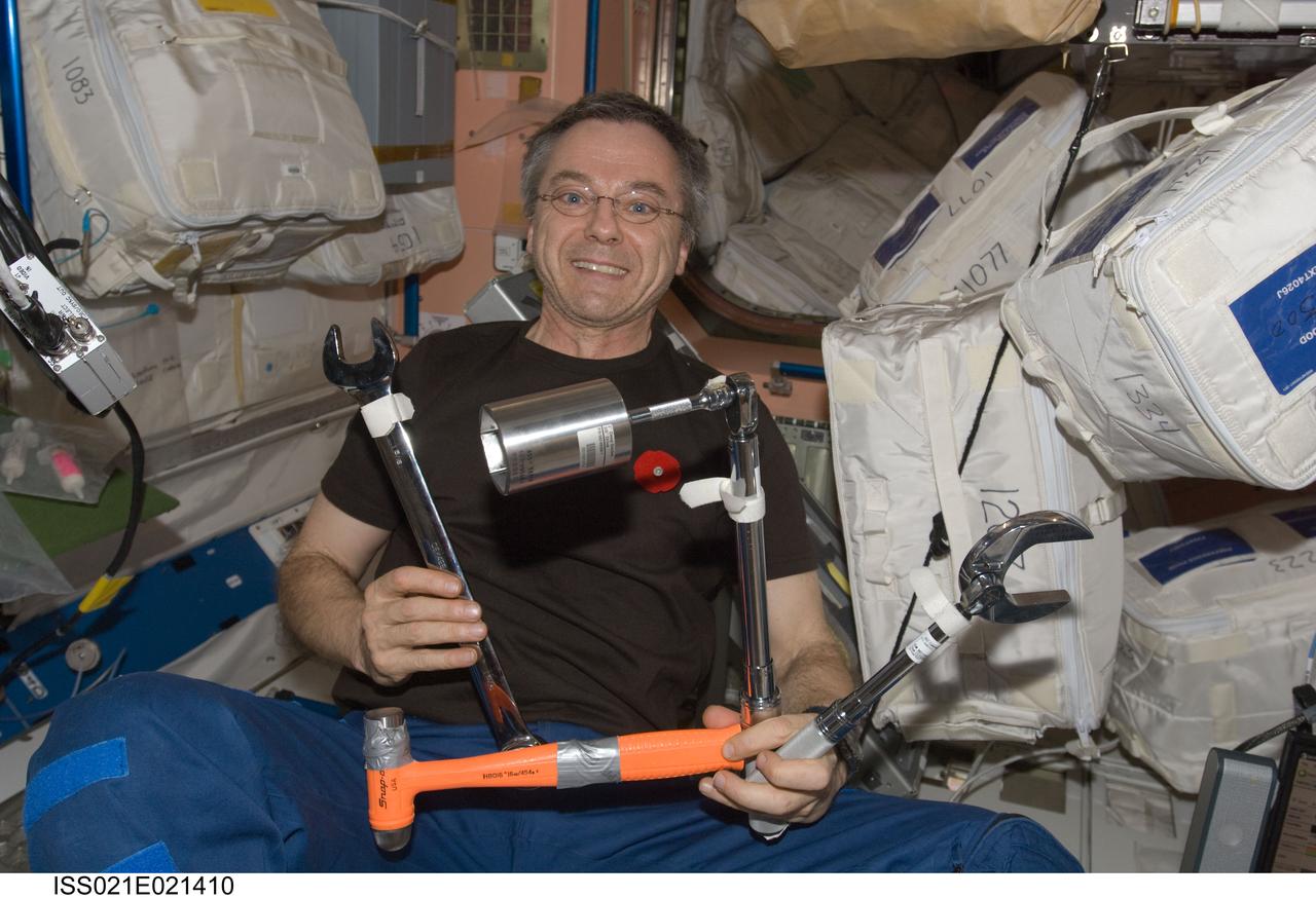 ISS021-E-021410 (3 Nov. 2009) --- Canadian Space Agency astronaut Robert Thirsk, Expedition 21 flight engineer, holds various tools in the Unity node of the International Space Station.