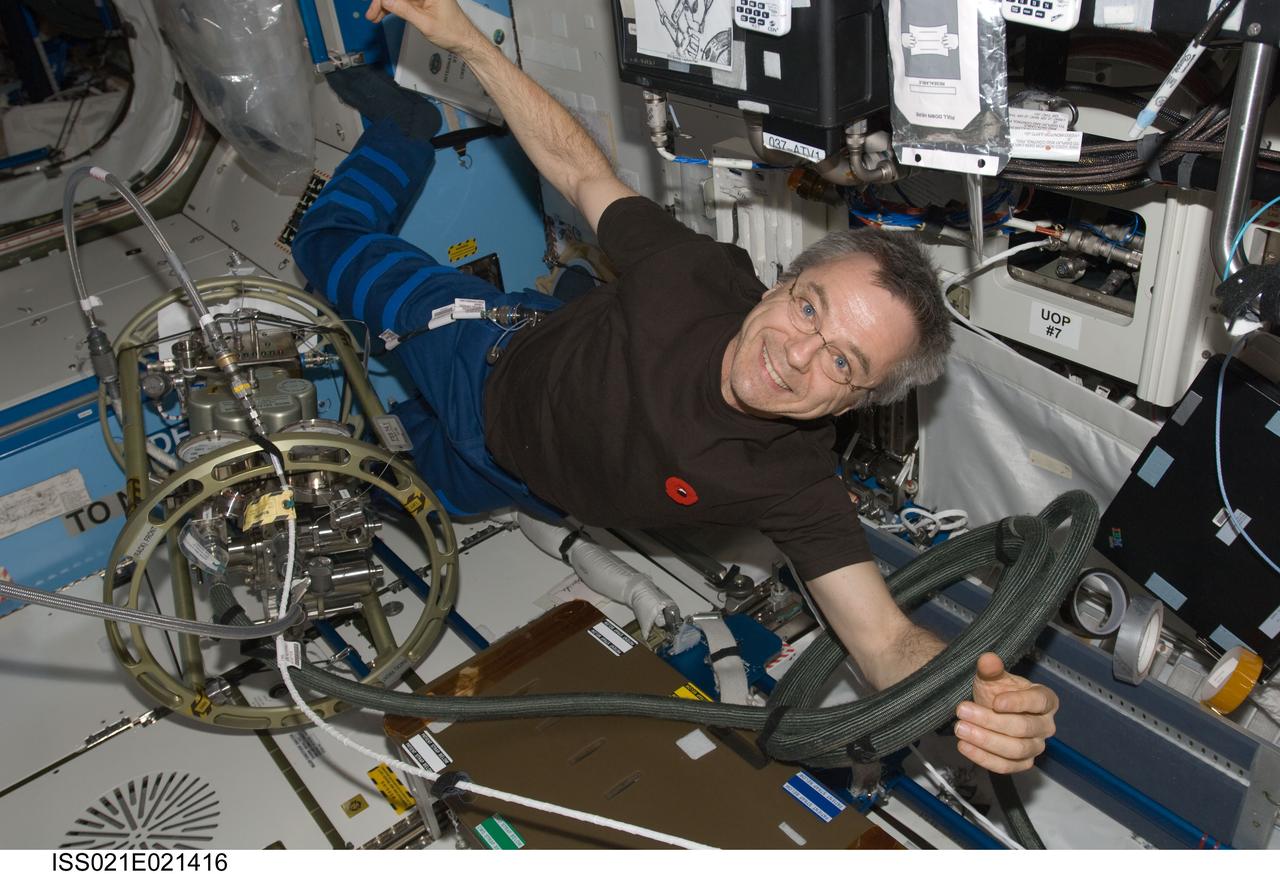 ISS021-E-021416 (5 Nov. 2009) --- Canadian Space Agency astronaut Robert Thirsk, Expedition 21 flight engineer, uses the Fluid Servicing System (FSS) to refill Internal Thermal Control System (ITCS) loops with fresh coolant in the Destiny laboratory of the International Space Station.