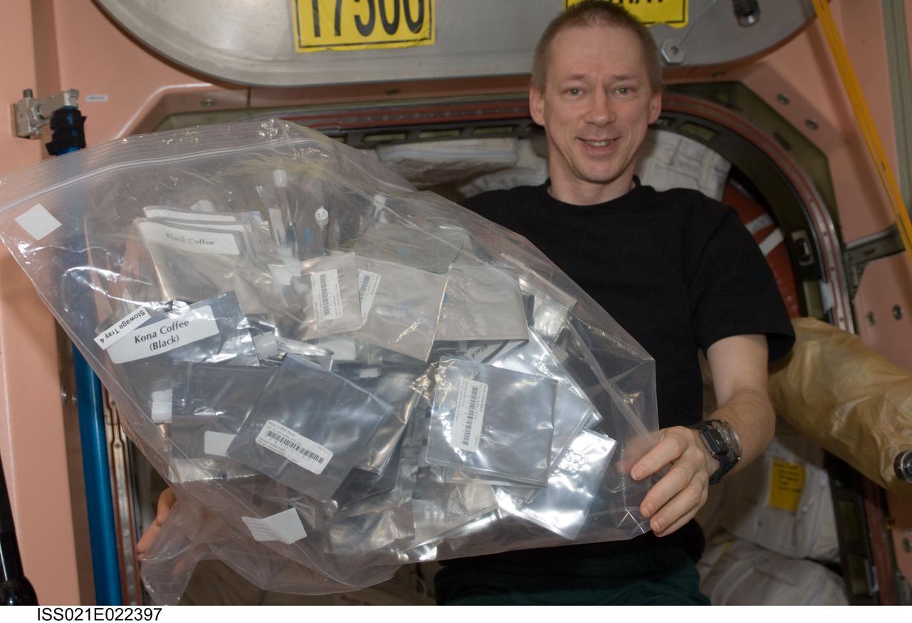 ISS021-E-022397 (8 Nov. 2009) --- European Space Agency astronaut Frank De Winne, Expedition 21 commander, holds a stowage bag containing various beverages in the Unity node of the International Space Station.