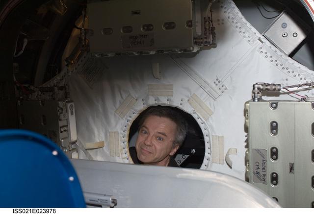 NASA image: FE Thirsk poses for a photo with a M/D Cover