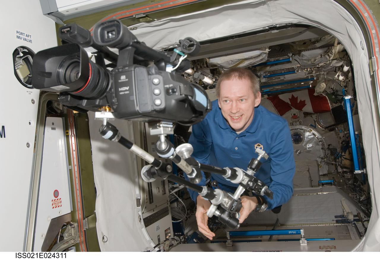 ISS021-E-024311 (12 Nov. 2009) --- European Space Agency astronaut Frank De Winne, Expedition 21 commander, moves a High Definition Video (HDV) camera and equipment from the Kibo laboratory into the Harmony node of the International Space Station.