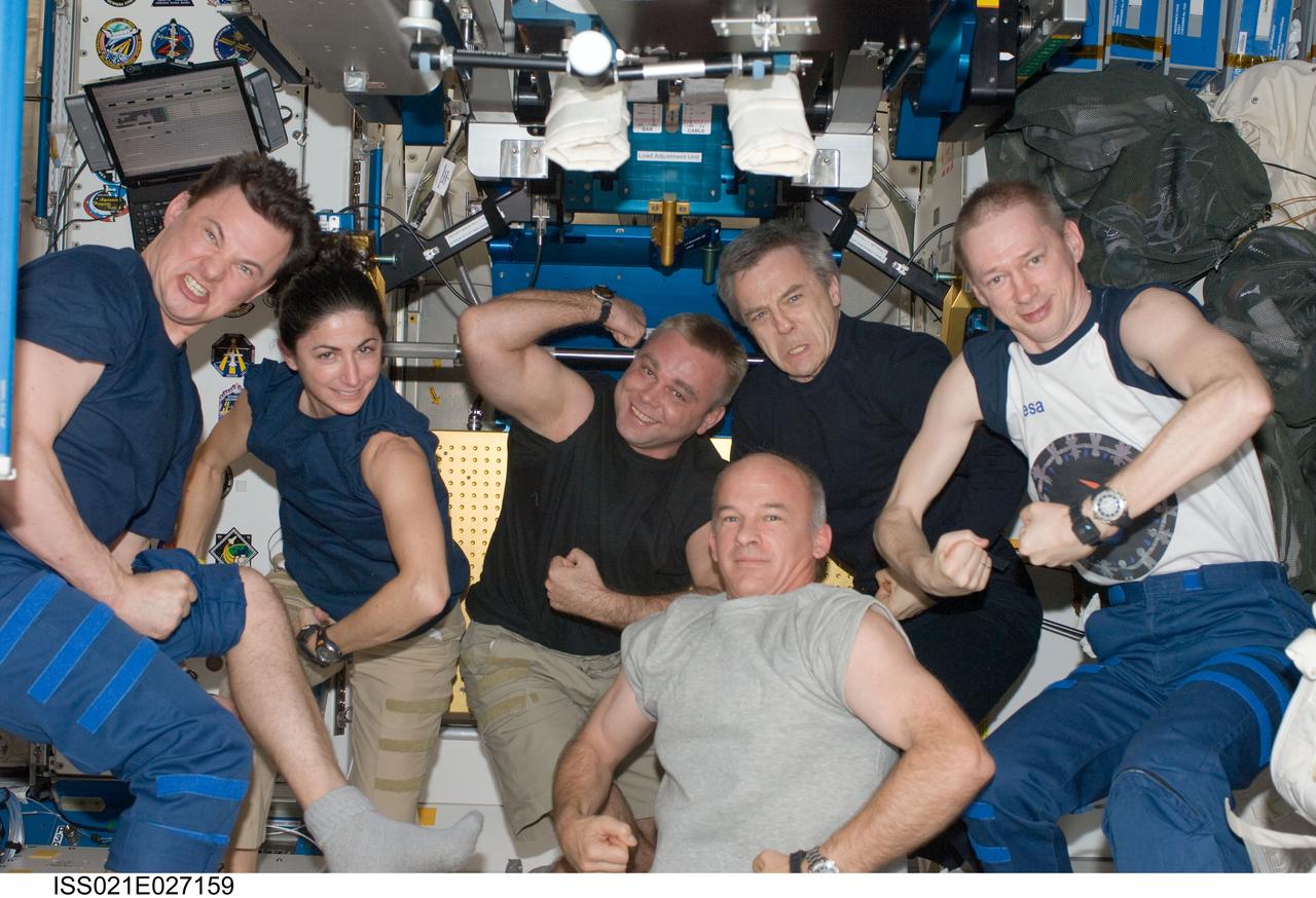 ISS021-E-027159 (15 Nov. 2009) --- European Space Agency astronaut Frank De Winne (right), Expedition 21 commander; Canadian Space Agency astronaut Robert Thirsk, NASA astronauts Jeffrey Williams (bottom) and Nicole Stott; along with Russian cosmonauts Maxim Suraev and Roman Romanenko (left), all flight engineers, enjoy a light moment in the Unity node of the International Space Station.