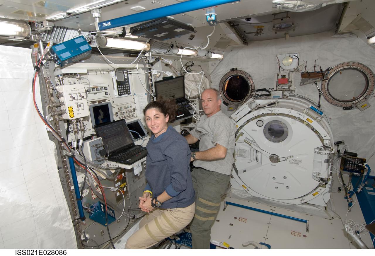 ISS021-E-028086 (17 Nov. 2009) --- NASA astronauts Jeffrey Williams and Nicole Stott, both Expedition 21 flight engineers, work in the Kibo laboratory of the International Space Station.