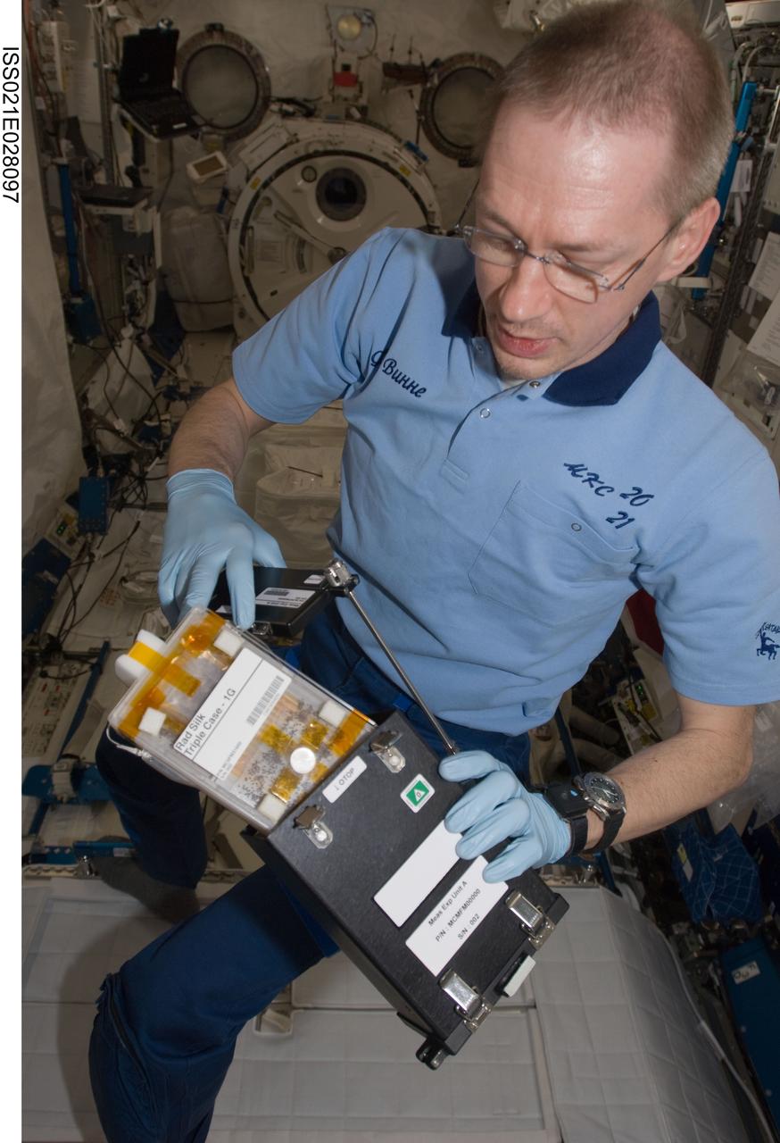 ISS021-E-028097 (17 Nov. 2009) --- European Space Agency astronaut Frank De Winne, Expedition 21 commander, works with the RadSilk experiment in the Kibo laboratory of the International Space Station. RadSilk examines the effects of radiation exposure in microgravity on silkworms.