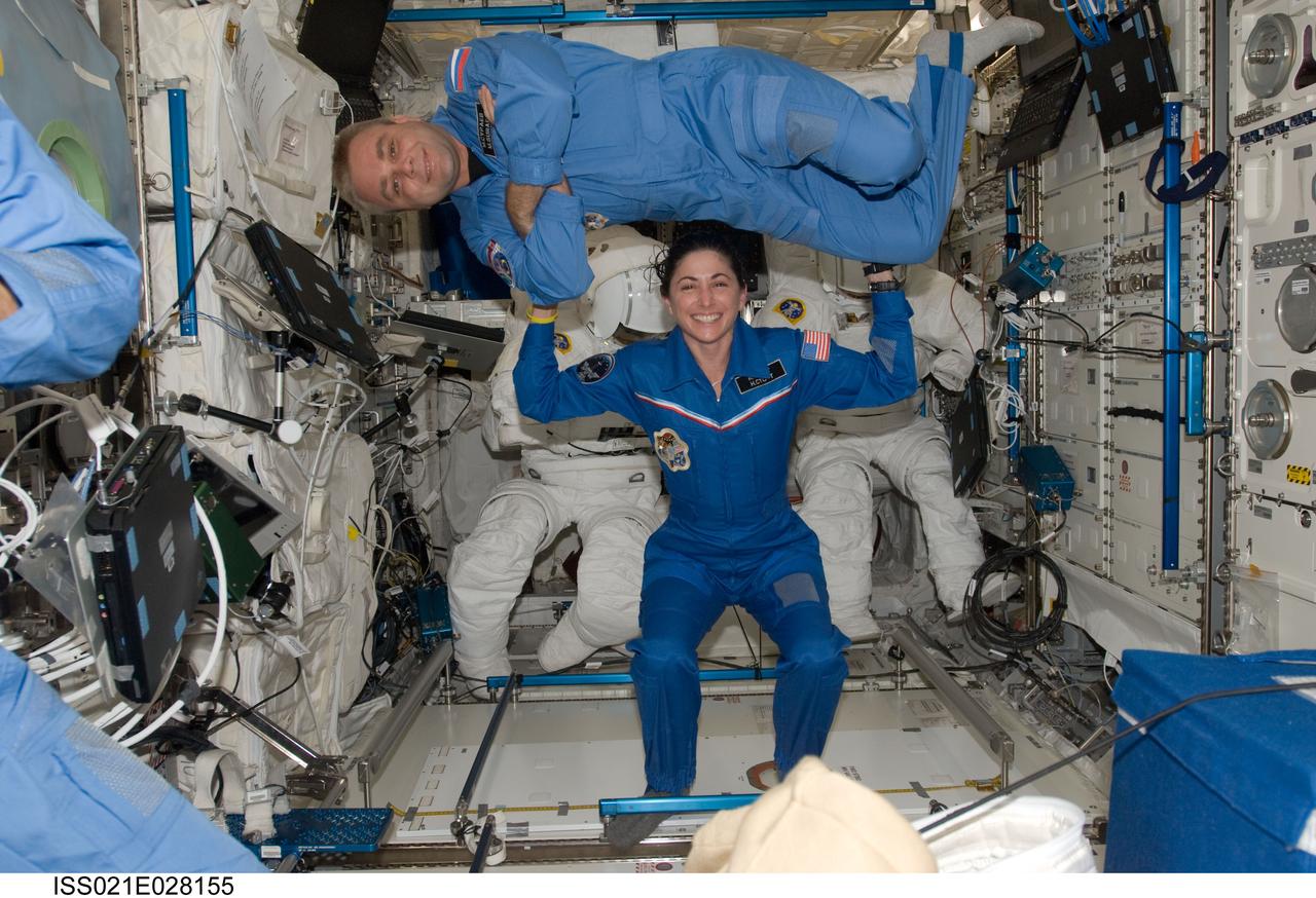 ISS021-E-028155 (17 Nov. 2009) --- NASA astronaut Nicole Stott and Russian cosmonaut Maxim Suraev, both Expedition 21 flight engineers, pose for a photo in the Columbus laboratory of the International Space Station.