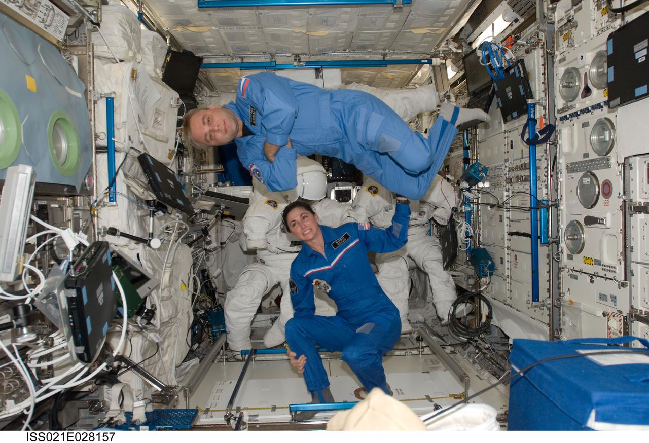ISS021-E-028157 (17 Nov. 2009) --- NASA astronaut Nicole Stott and Russian cosmonaut Maxim Suraev, both Expedition 21 flight engineers, pose for a photo in the Columbus laboratory of the International Space Station.