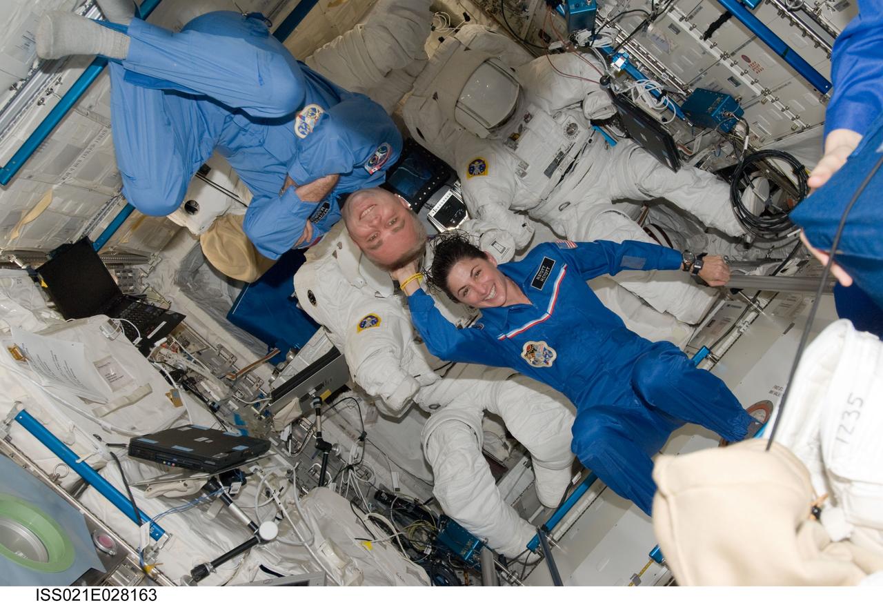 ISS021-E-028163 (17 Nov. 2009) --- NASA astronaut Nicole Stott and Russian cosmonaut Maxim Suraev, both Expedition 21 flight engineers, pose for a photo in the Columbus laboratory of the International Space Station.