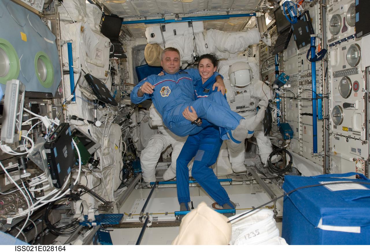 ISS021-E-028164 (17 Nov. 2009) --- NASA astronaut Nicole Stott and Russian cosmonaut Maxim Suraev, both Expedition 21 flight engineers, pose for a photo in the Columbus laboratory of the International Space Station.